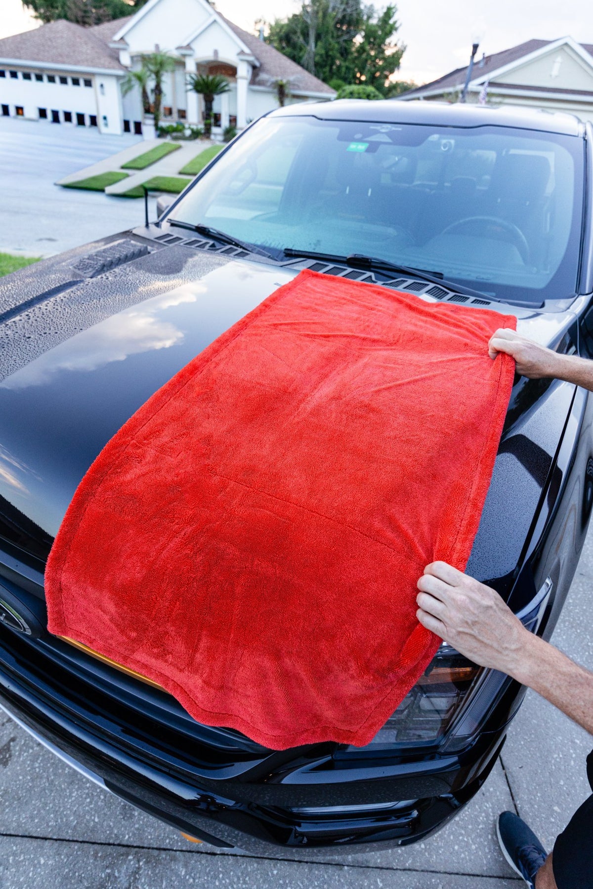 Step 3 dry: Twisted Loop Drying Towel on a black truck hood